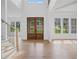 Bright entry with hardwood floors, double doors, and staircase at 5693 Brendlynn Dr, Suwanee, GA 30024