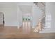 Hardwood floor hallway with staircase and views to living areas at 5693 Brendlynn Dr, Suwanee, GA 30024