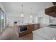 Elegant kitchen with a large island, breakfast bar, and open living area view at 5693 Brendlynn Dr, Suwanee, GA 30024