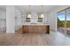 Modern kitchen with island, white cabinets, and hardwood floors at 5693 Brendlynn Dr, Suwanee, GA 30024