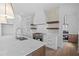 Modern kitchen with white cabinets, marble countertops and a statement range hood at 5693 Brendlynn Dr, Suwanee, GA 30024