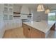 Bright kitchen featuring a spacious island and stainless steel appliances at 5693 Brendlynn Dr, Suwanee, GA 30024