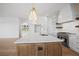 Modern kitchen island with white quartz countertop and a gold faucet at 5693 Brendlynn Dr, Suwanee, GA 30024
