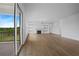 Open living room with hardwood floors and access to deck with scenic views at 5693 Brendlynn Dr, Suwanee, GA 30024
