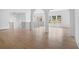 Open loft area with hardwood floors, arched entryways, and a modern chandelier at 5693 Brendlynn Dr, Suwanee, GA 30024