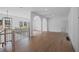 Open loft area with hardwood floors, arched entryways, and a modern chandelier at 5693 Brendlynn Dr, Suwanee, GA 30024