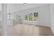 Bright loft area with hardwood floors, black railing, and a modern light fixture at 5693 Brendlynn Dr, Suwanee, GA 30024
