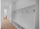 Functional mudroom with built-in bench, cubbies, and hooks for storage at 5693 Brendlynn Dr, Suwanee, GA 30024