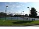 Well-lit tennis courts with surrounding fence at 5693 Brendlynn Dr, Suwanee, GA 30024