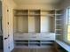 Bright walk-in closet with custom shelving and drawers at 5693 Brendlynn Dr, Suwanee, GA 30024