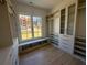 Well-organized walk-in closet with custom built-ins and natural light at 5693 Brendlynn Dr, Suwanee, GA 30024