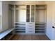 Custom-designed walk-in closet with built-in shelves and drawers at 5693 Brendlynn Dr, Suwanee, GA 30024