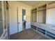 Large walk-in closet with window, built-in shelving, and drawers at 5693 Brendlynn Dr, Suwanee, GA 30024