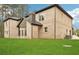 A lush green yard surrounds a brick home with a covered patio at 2861 Tree Top Rd, Dacula, GA 30019