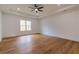 Spacious primary bedroom features a tray ceiling, ceiling fan, and large window at 2861 Tree Top Rd, Dacula, GA 30019