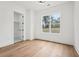 Bedroom with wood floors and large window providing natural light, with walk in closet at 2861 Tree Top Rd, Dacula, GA 30019