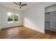 This bedroom features light-colored wood flooring, white walls, and a ceiling fan at 2861 Tree Top Rd, Dacula, GA 30019
