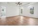 Spacious bedroom with hardwood floors, ceiling fan, and recessed lighting; en suite bathroom is visible through door at 2861 Tree Top Rd, Dacula, GA 30019