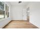 Bedroom with wood floors and large window providing natural light at 2861 Tree Top Rd, Dacula, GA 30019