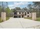 View of the house from the end of the driveway, with pillars on either side at 2861 Tree Top Rd, Dacula, GA 30019