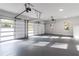 Spacious three car garage featuring ample space, bright lighting and convenient garage doors at 2861 Tree Top Rd, Dacula, GA 30019