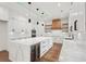 Modern kitchen with a large island, wine cooler, and white cabinetry at 2861 Tree Top Rd, Dacula, GA 30019