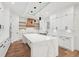 Modern kitchen features white cabinets, marble countertops, a large island, and stainless steel appliances at 2861 Tree Top Rd, Dacula, GA 30019