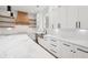 This kitchen features white cabinets, marble countertops, a large island, and stainless steel appliances at 2861 Tree Top Rd, Dacula, GA 30019