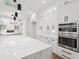 This kitchen features white cabinets, marble countertops, stainless steel appliances, and a large island at 2861 Tree Top Rd, Dacula, GA 30019