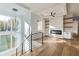 Open-concept living area with fireplace, built-in shelves, hardwood floors, and modern lighting at 2861 Tree Top Rd, Dacula, GA 30019