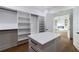 Spacious walk-in closet with custom built in shelving and center storage island at 2861 Tree Top Rd, Dacula, GA 30019