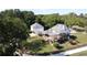 Aerial view highlighting the expansive deck, outbuildings, and well-maintained landscaping surrounding the beautiful white home at 3898 Ridge Rd, Buford, GA 30519