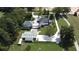 Wide aerial view of the estate, showcasing multiple buildings, including a charming home, an outbuilding, and green lawns at 3898 Ridge Rd, Buford, GA 30519