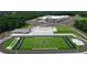 Aerial view of school campus featuring athletic field, modern facilities and surrounding greenery at 3898 Ridge Rd, Buford, GA 30519