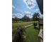 Picturesque back yard featuring lush lawn, mature trees and open field beyond the fence at 3898 Ridge Rd, Buford, GA 30519