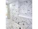 Walk-in shower with designer tile, a pebble floor, and a glass partition at 3898 Ridge Rd, Buford, GA 30519