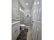 Modern bathroom featuring a glass-enclosed shower with pebble floor and elegant white cabinetry at 3898 Ridge Rd, Buford, GA 30519
