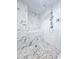 Custom tiled shower with pebble floor, multiple shower heads, and a built-in bench at 3898 Ridge Rd, Buford, GA 30519