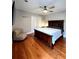 Bedroom featuring hardwood floors, large closet, and natural light creating a calming atmosphere at 3898 Ridge Rd, Buford, GA 30519
