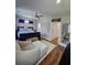 Cozy bedroom showcasing hardwood floors, a ceiling fan, and a comfortable armchair with ottoman at 3898 Ridge Rd, Buford, GA 30519