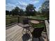 Outdoor deck space featuring a table, two chairs, and a scenic backyard view at 3898 Ridge Rd, Buford, GA 30519