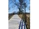 Spacious driveway surrounded by wooden fences and lush fields for a peaceful arrival at 3898 Ridge Rd, Buford, GA 30519