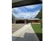 Charming home featuring a well-manicured lawn, long driveway, and red exterior with a green metal roof at 3898 Ridge Rd, Buford, GA 30519