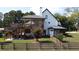 Backyard exterior of a home featuring a two-level wooden deck and manicured lawn at 3898 Ridge Rd, Buford, GA 30519