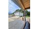Backyard exterior featuring a white home, a detached garage, and concrete driveway at 3898 Ridge Rd, Buford, GA 30519