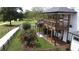 Backyard exterior view showcases an elevated deck, white siding, and wooden fence at 3898 Ridge Rd, Buford, GA 30519