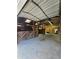 Spacious horse barn featuring wooden stalls, a metal roof, and ample lighting for comfortable animal care at 3898 Ridge Rd, Buford, GA 30519