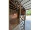 Well-kept horse stall with wooden panels, a ceiling fan, and gated entry for easy animal management at 3898 Ridge Rd, Buford, GA 30519