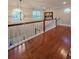 Landing featuring hardwood floors, natural light, decorative art, and a chandelier at 3898 Ridge Rd, Buford, GA 30519
