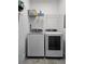 Functional laundry room featuring a modern washer and dryer set with overhead shelving at 3898 Ridge Rd, Buford, GA 30519